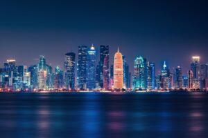 body of water across city buildings during nighttime