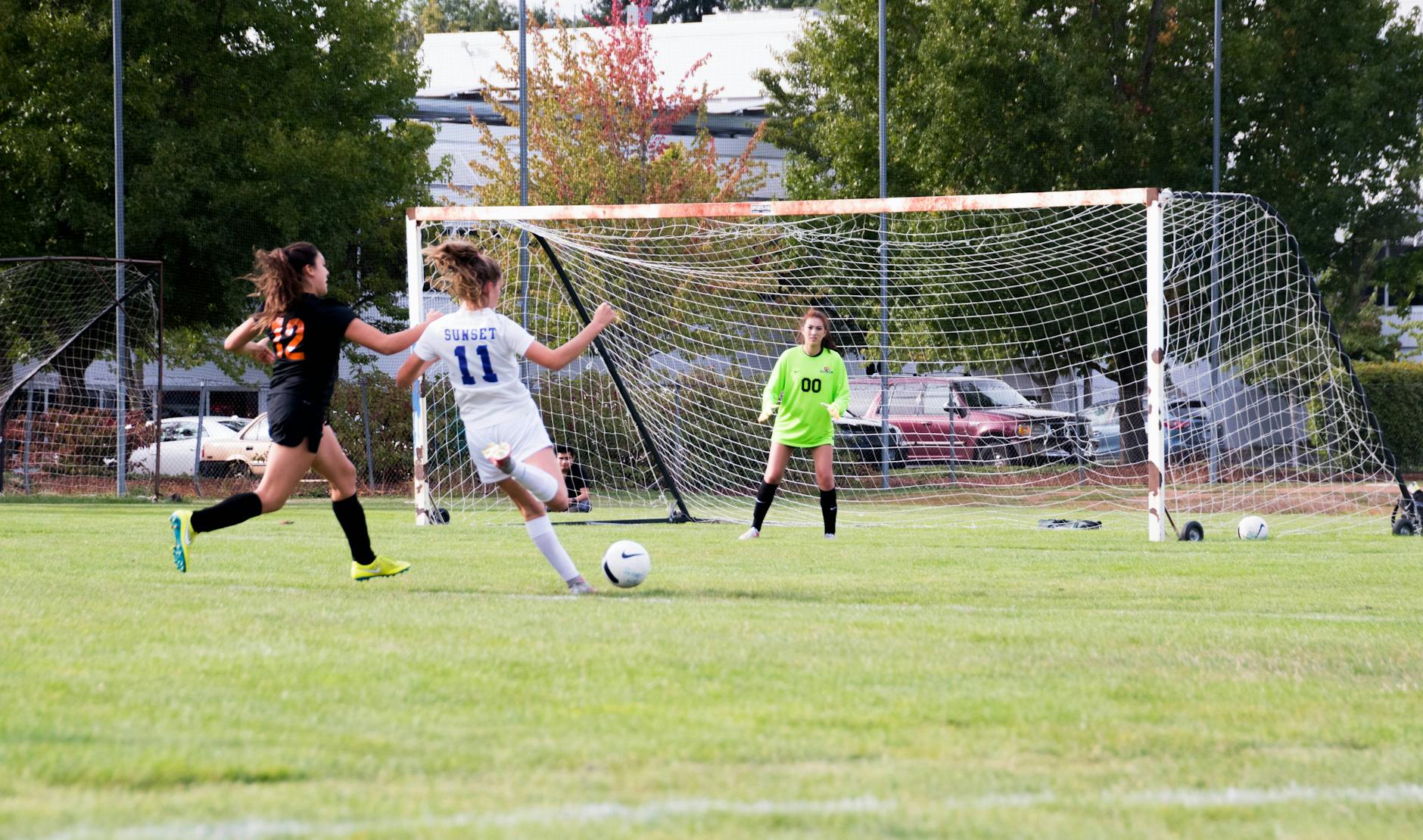 three women playing soccer game